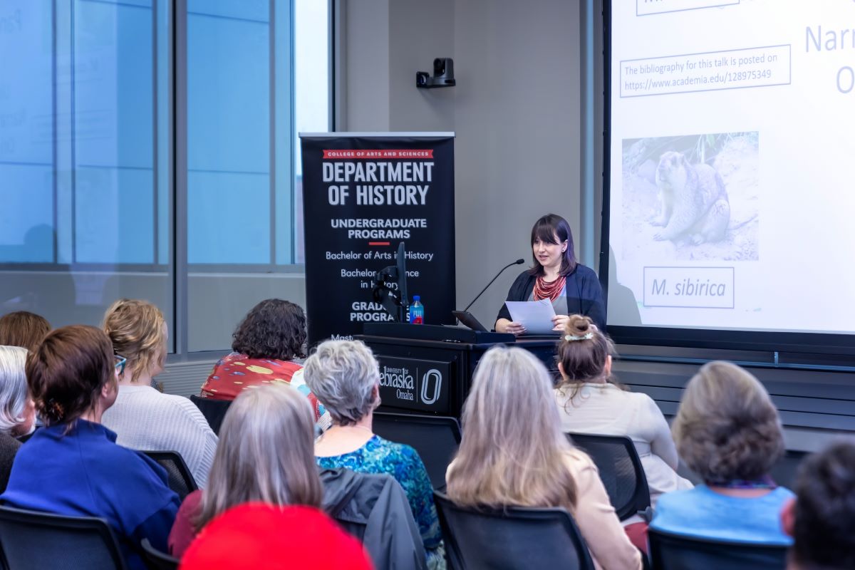 A professor addresses a crowd