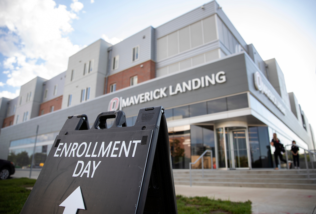 A sign reading "Enrollment Day" points towards the Maverick Landing.