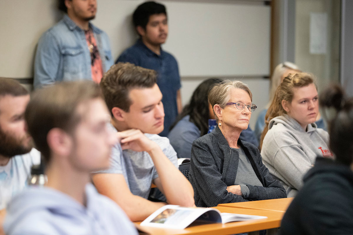 Josée Bak, Samuel Bak's wife, sits among students