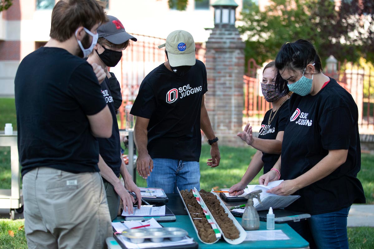 UNO students analyzing soil samples at an outdoor table