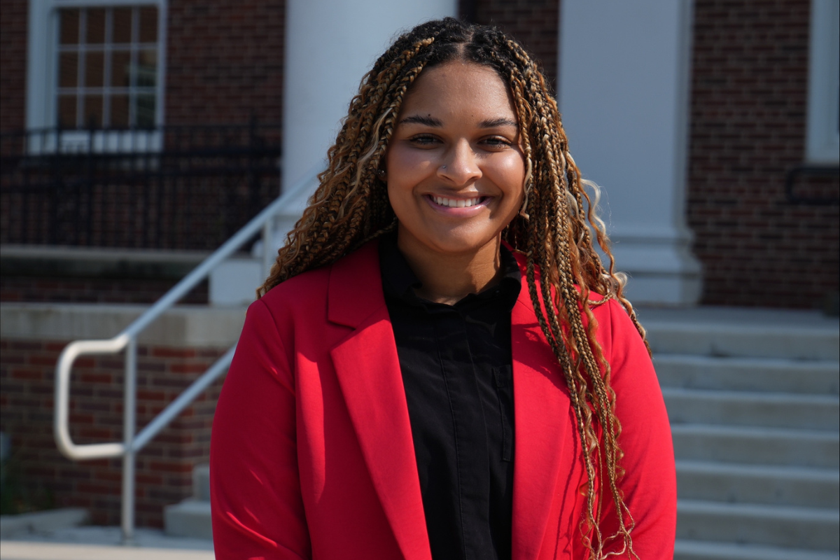 Deja Harris stands in front of Arts and Sciences Hall. 