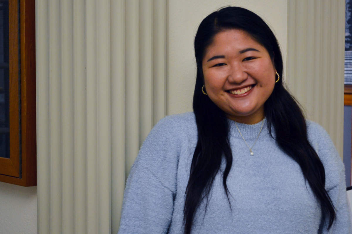 Saki Fukuda wears a blue sweater.