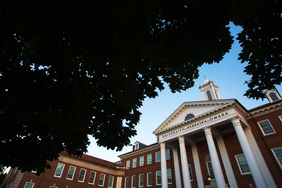 Arts & Sciences Hall surrounded by trees. 