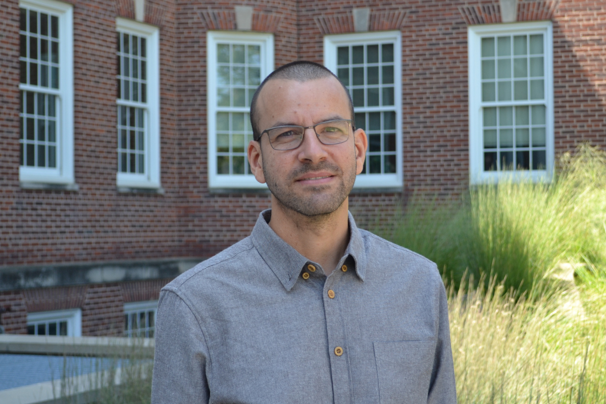 Omri Senderowicz stands in front of Arts & Sciences Hall. 
