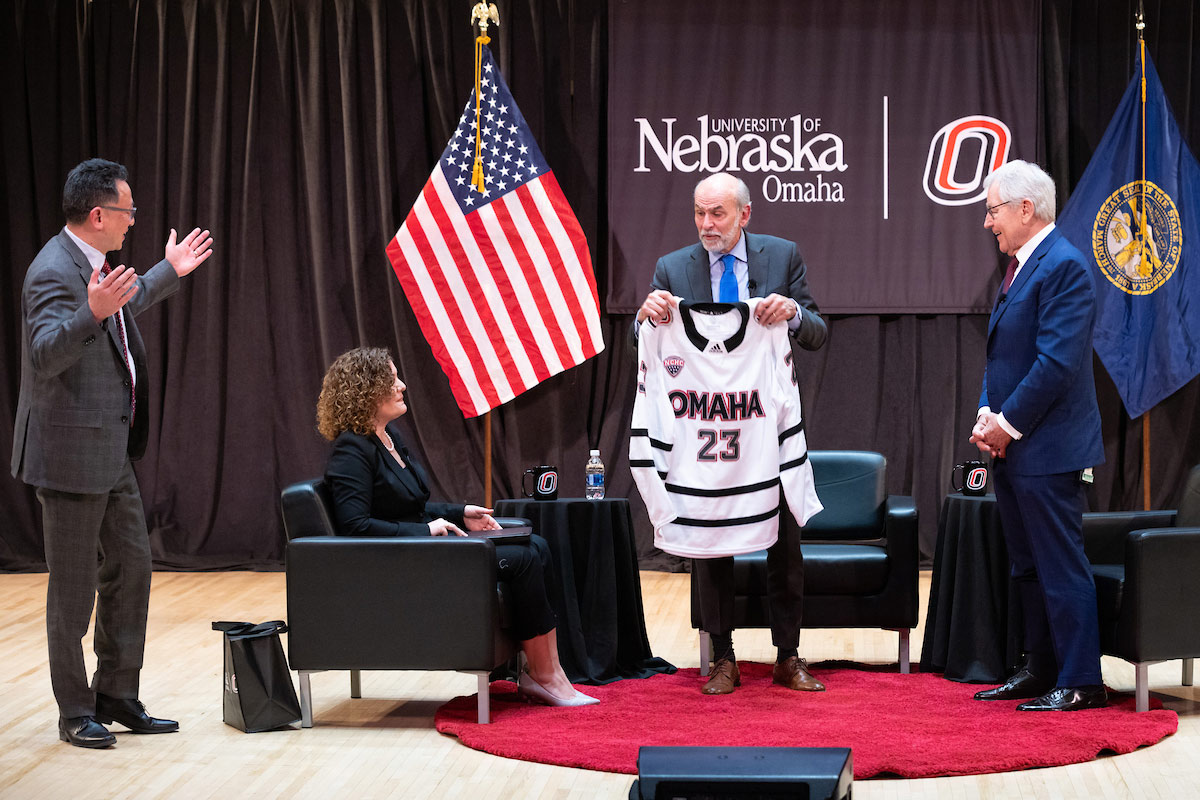 Seib was present with a custom Omaha Hockey jersey by Phil He, Ph.D., senior vice chancellor for academic affairs (left).