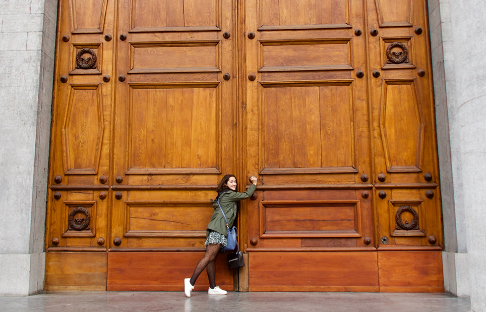 Young woman opening door