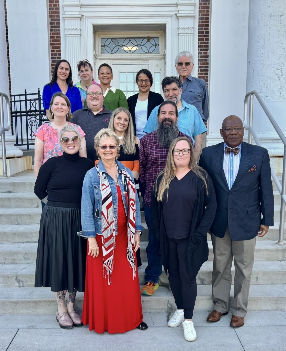The Sociology and Anthropology department faculty members stand smiling on the front stairs of the Arts and Science Hall