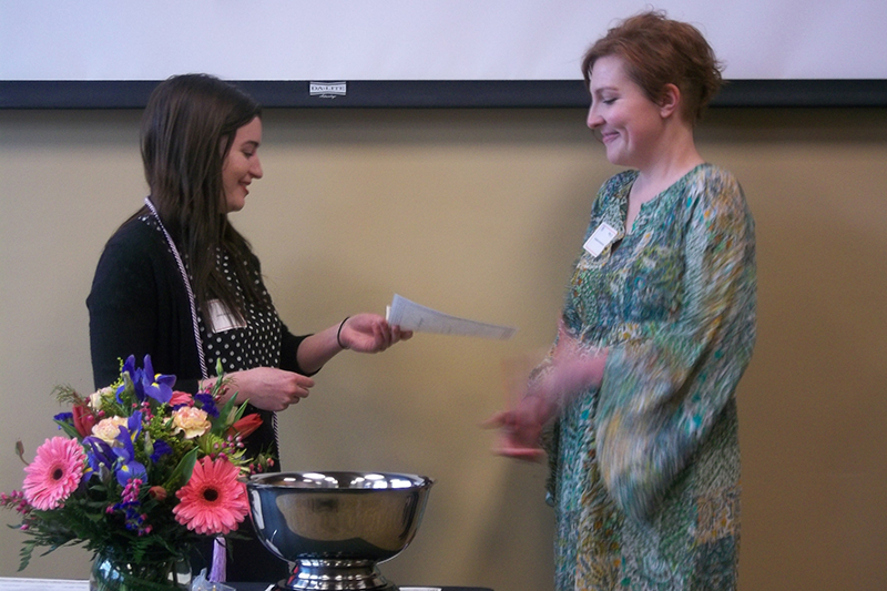 Two officers hand a piece of paper to one another.