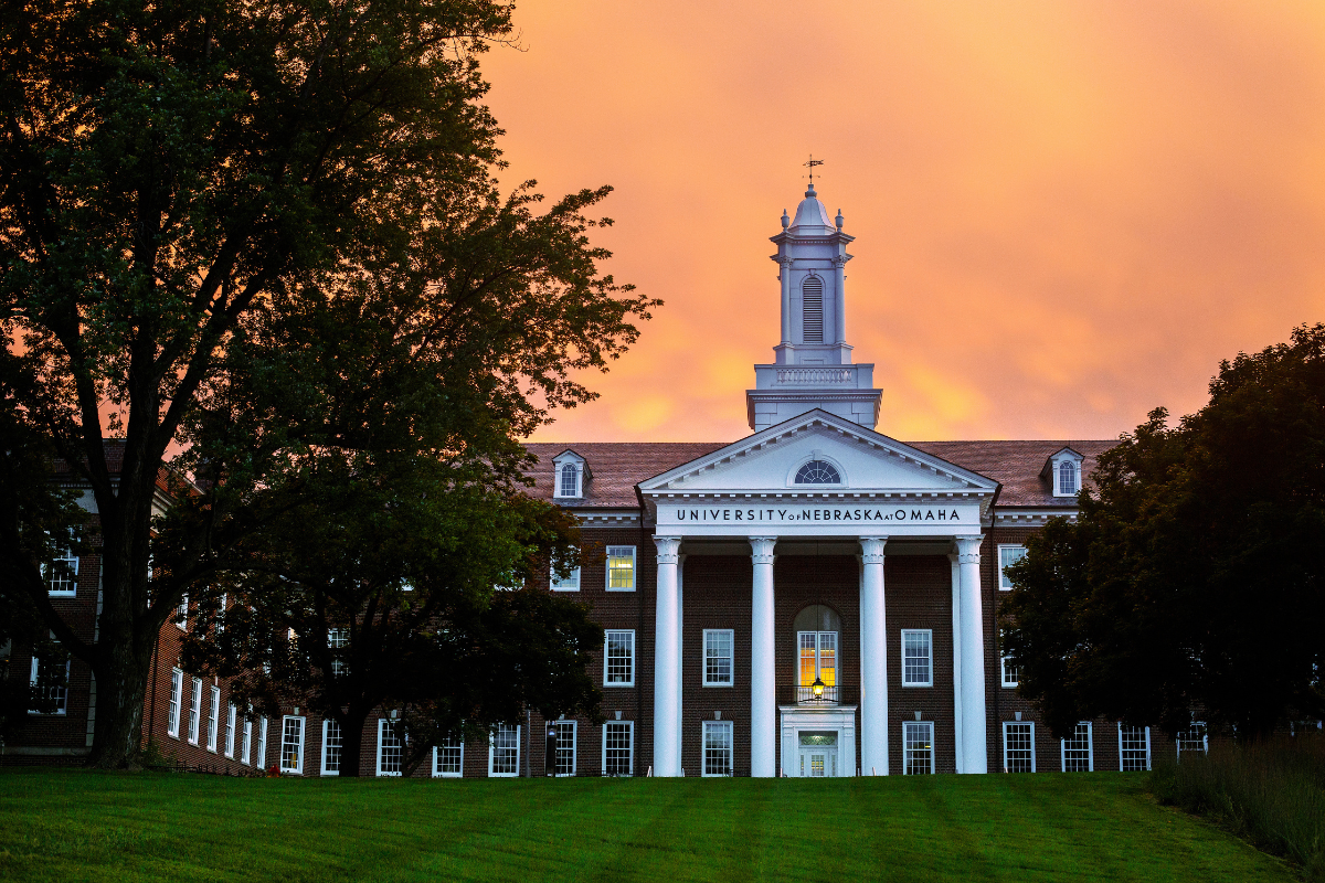 Arts & Sciences Hall surrounded by an orange sky.