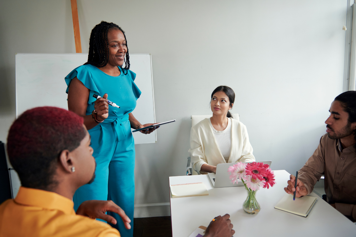 A woman speaks with her colleagues.