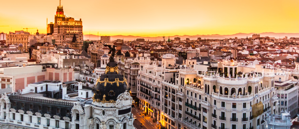A sky-high view of the streets of Madrid and the historic buildings that surround it. 