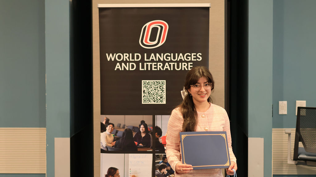 Student holding her award certificate