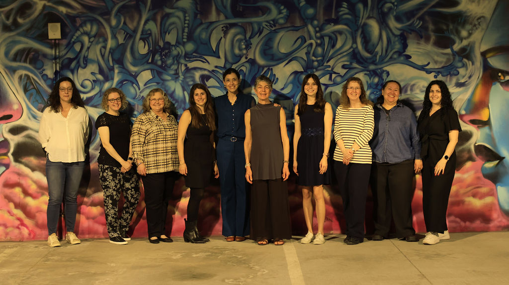 World Languages & Literature Faculty and Staff Pose in Front of Mural