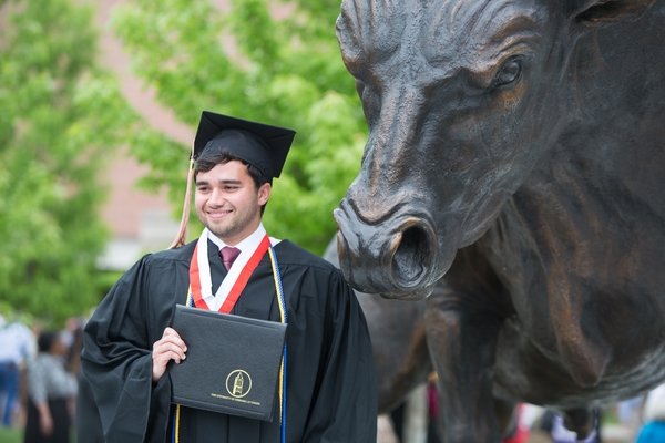 graduate holding diploma