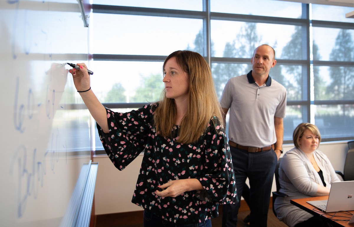 student writing on white board