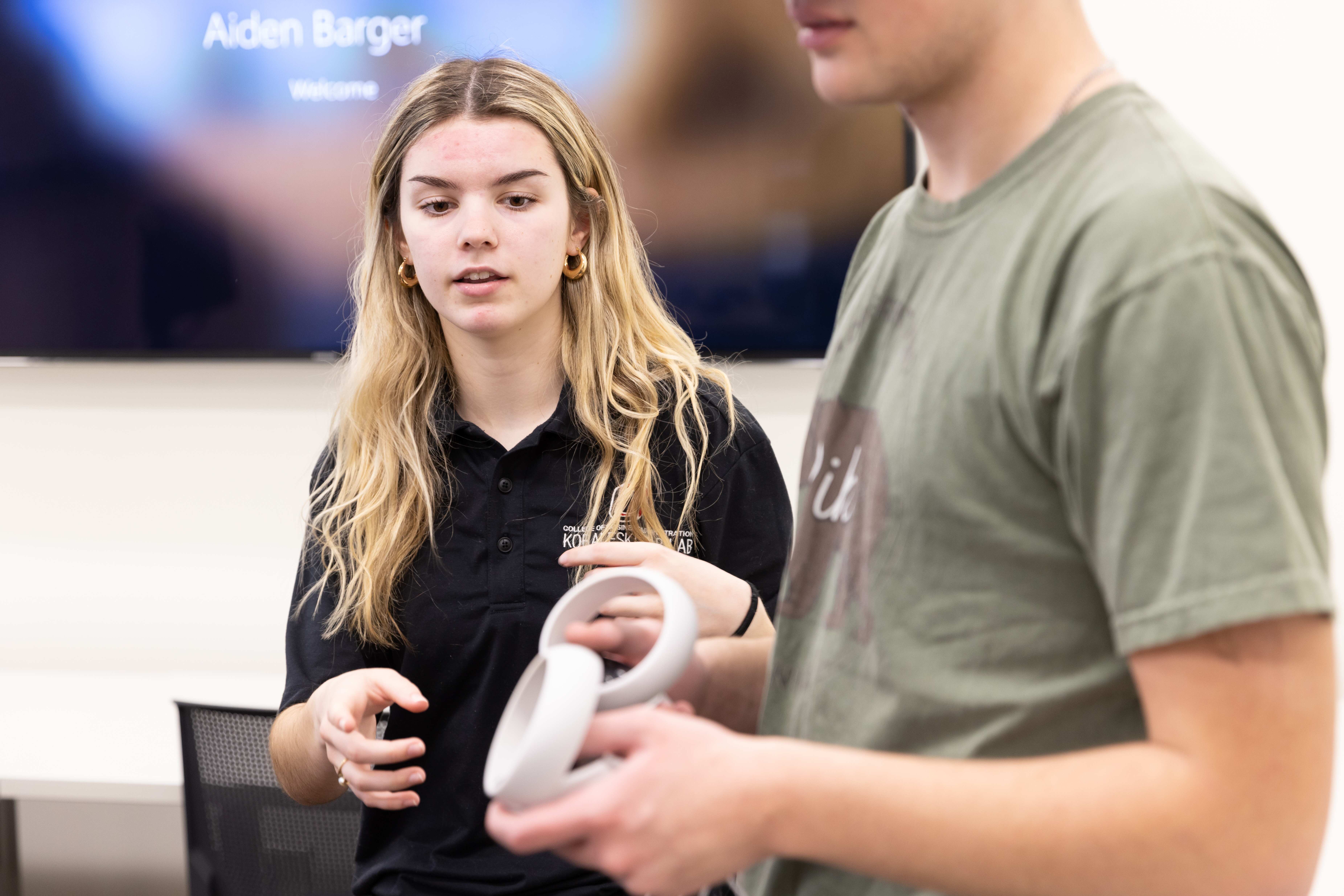 Proctor assisting participant using a VR device.
