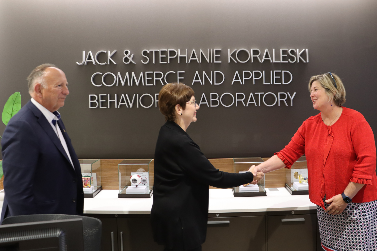 Dean Trawick shakes Stephanie Koraleski's hand