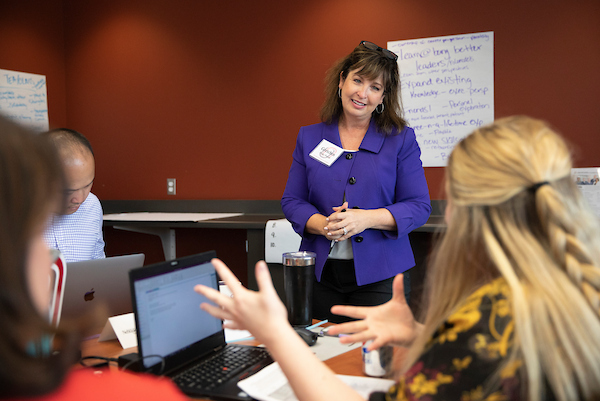Woman speaking to class.