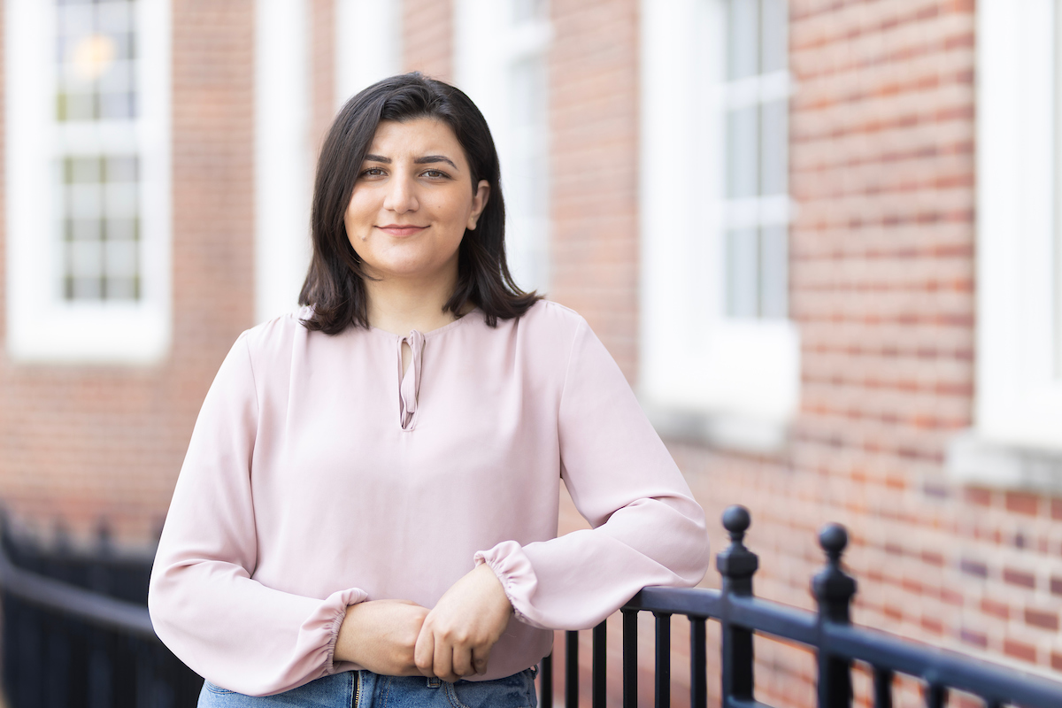 An image of a woman smiling at the camera in business clothes