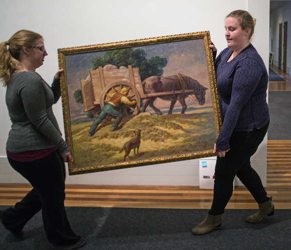 students carry a painting