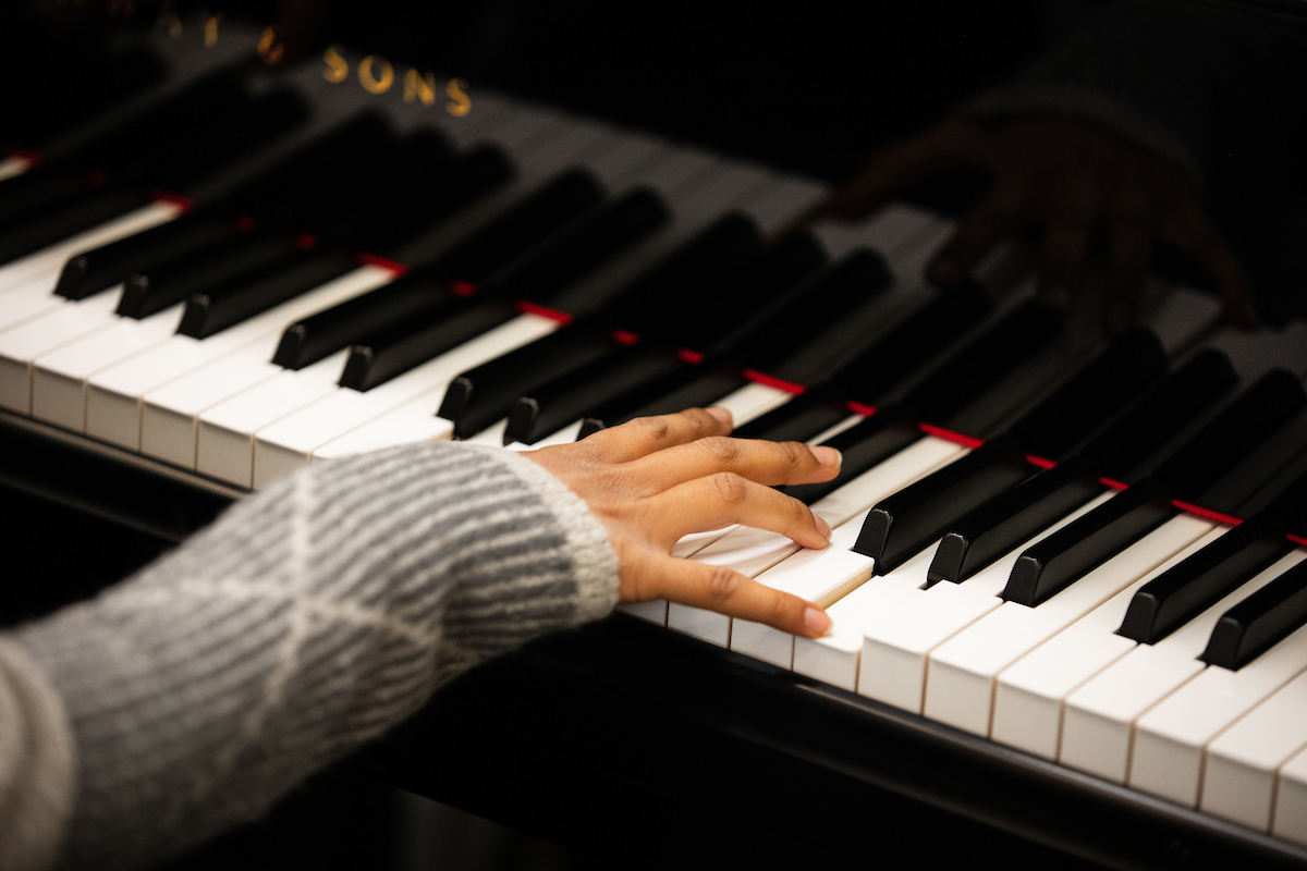 Close up hand playing piano