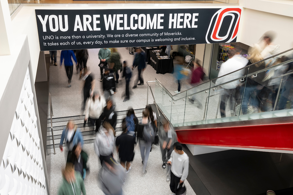 People come and go at UNO's Milo Bail Student Center, a large banner reads: You Are Welcome Here