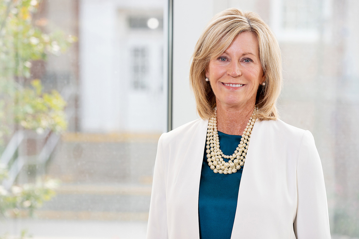 Nancy Edick, Ed.D., Lois G. Roskens Dean of the College of Education, Health, and Human Sciences (CEHHS) stands in the atrium of Roskens Hall
