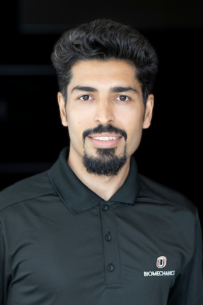 a person with short black hair and a goatee.