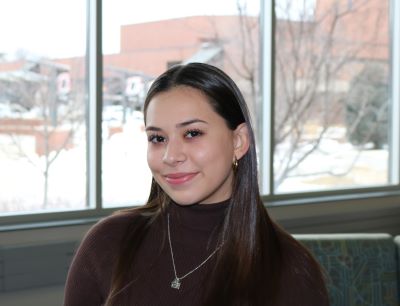 photo of isabella arrayales standing in front of a window