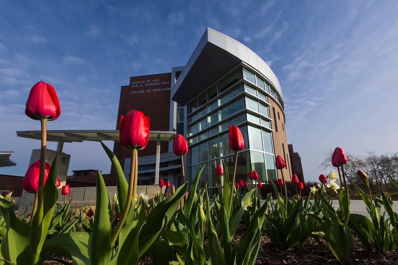 Roskens Hall exterior with red tulips
