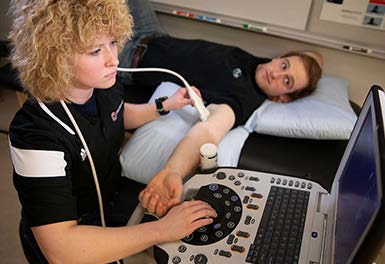 exercise science student conducting ultrasound on fellow student