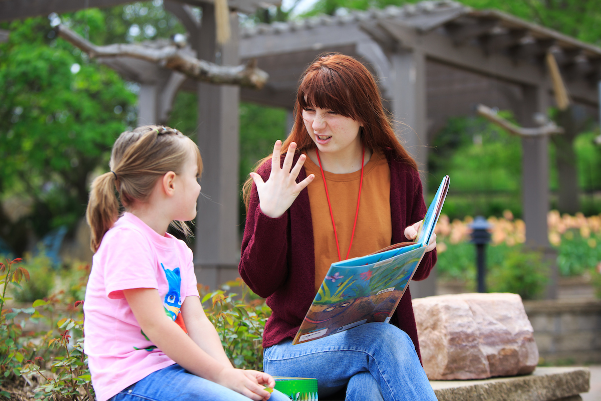Education student reading to a child