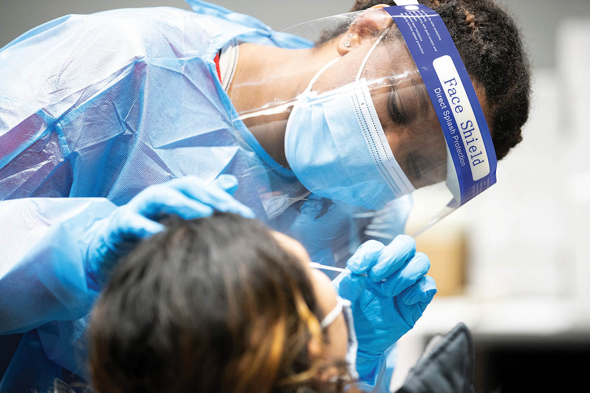 UNO Public Health student Rhea Flowers administers a COVID-19 test to a fellow studen