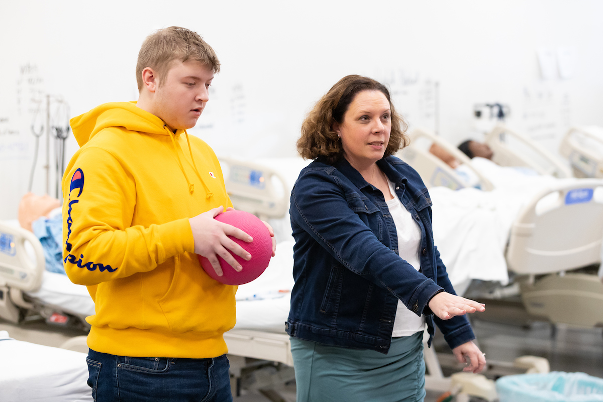 Robyn Jernigan works with Benson High School students in the lab