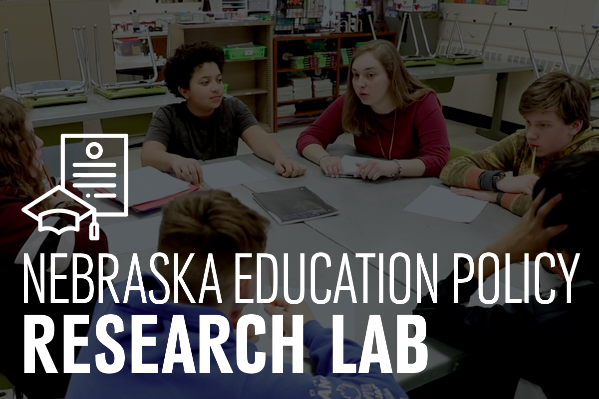 A teacher in a classroom sits at a table with middle school students, text over the photo reads Nebraska Education Policy Research Lab