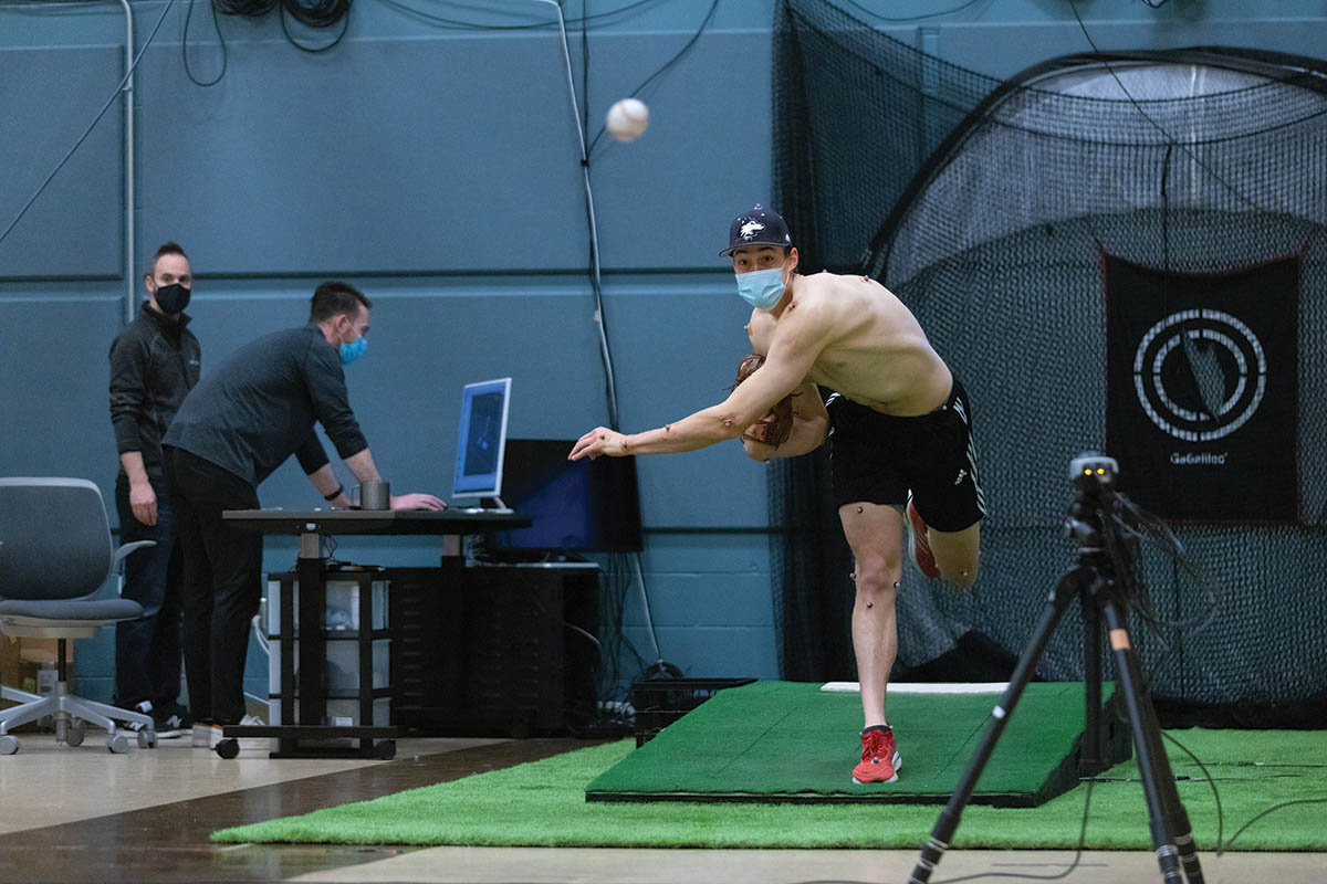 A pitcher throws a ball in the Pitching Lab