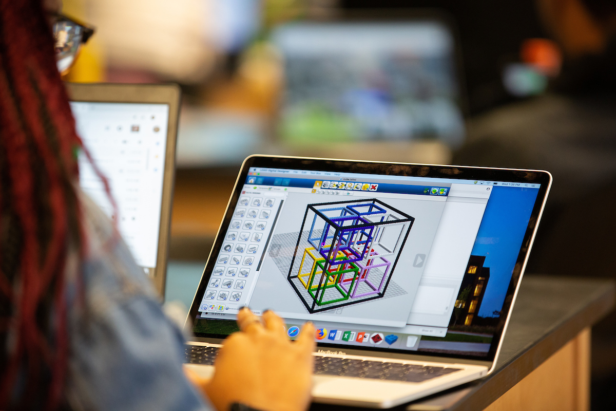 Student works on a laptop showing math and problem solving software