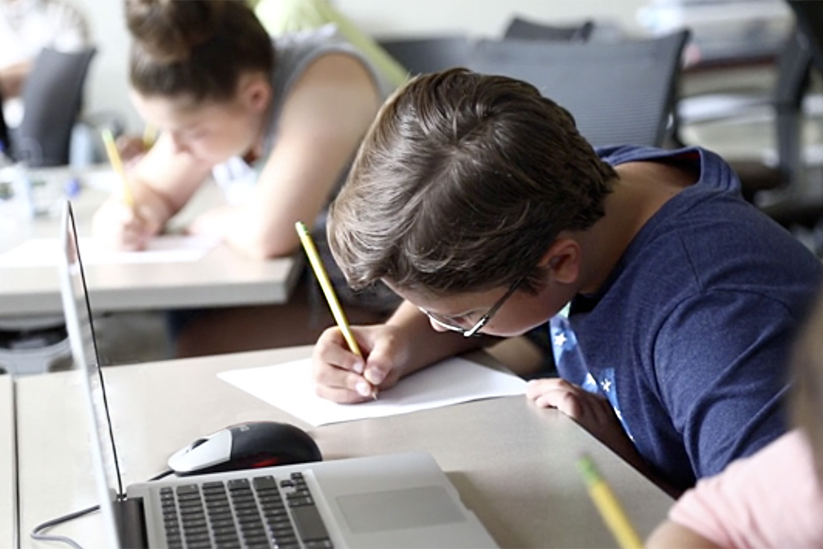 Students work on writing in a classroom