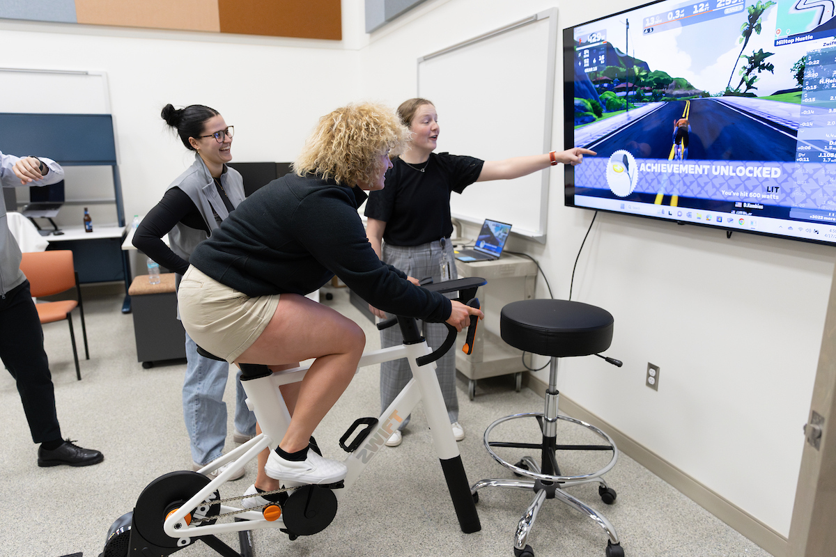 A person rides an exercise bike in a lab