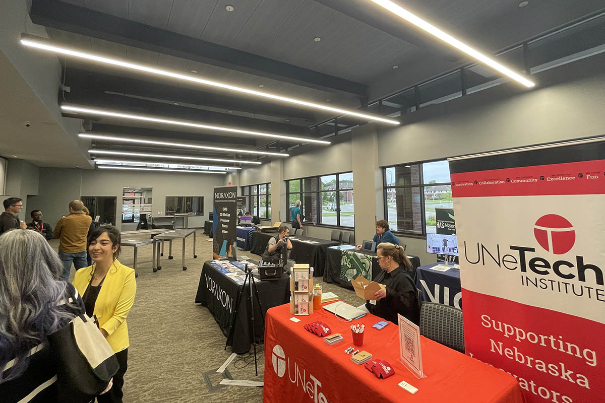 A tabling event at a conference, attendees mill around