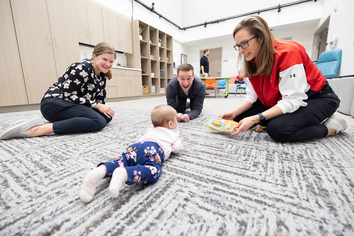 Dr. Danae Dinkel works with a baby in the new Health Science Collaborative at UNO