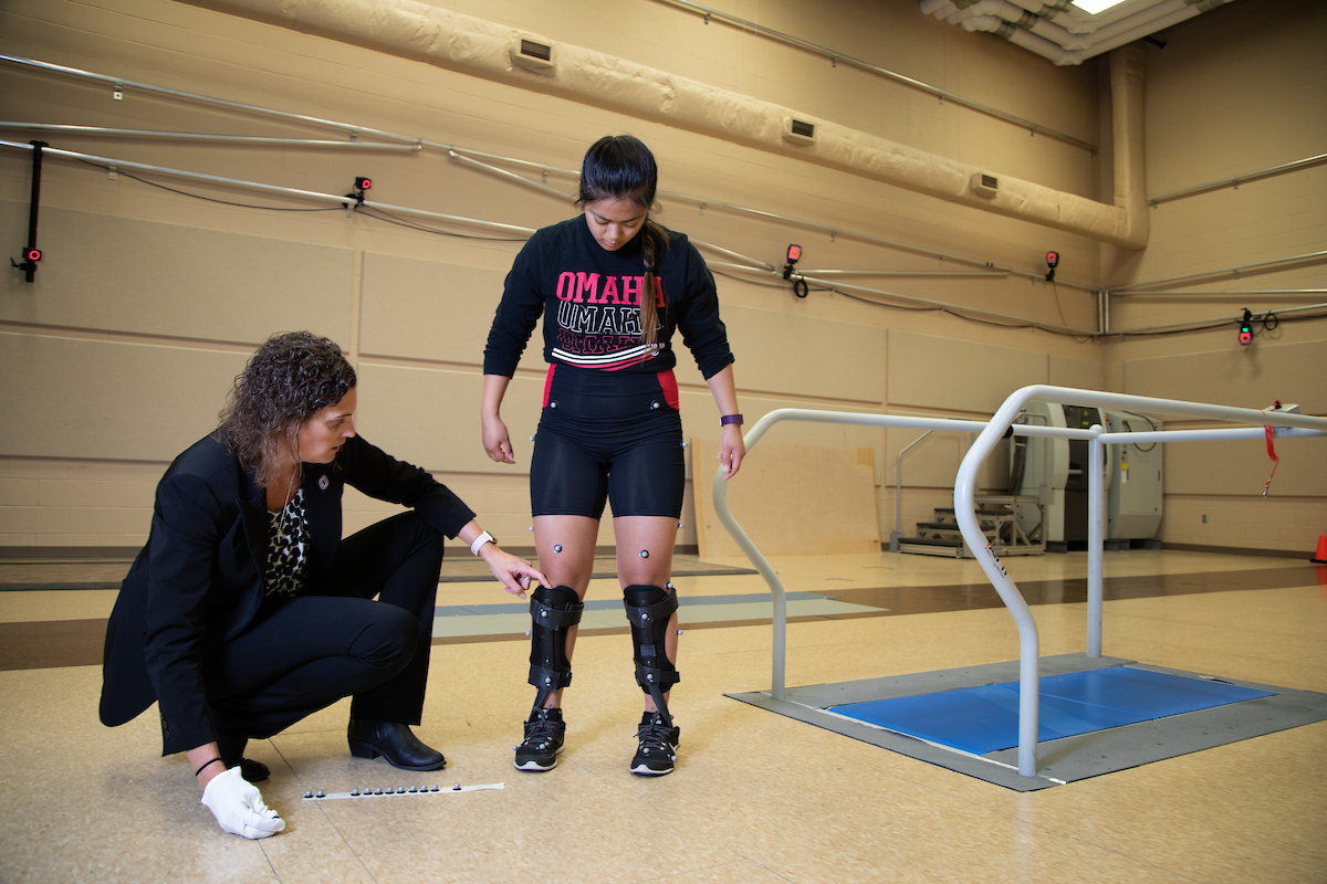 Dr. Sara Myers works with a research subject in the Biomechanics Research Building at UNO