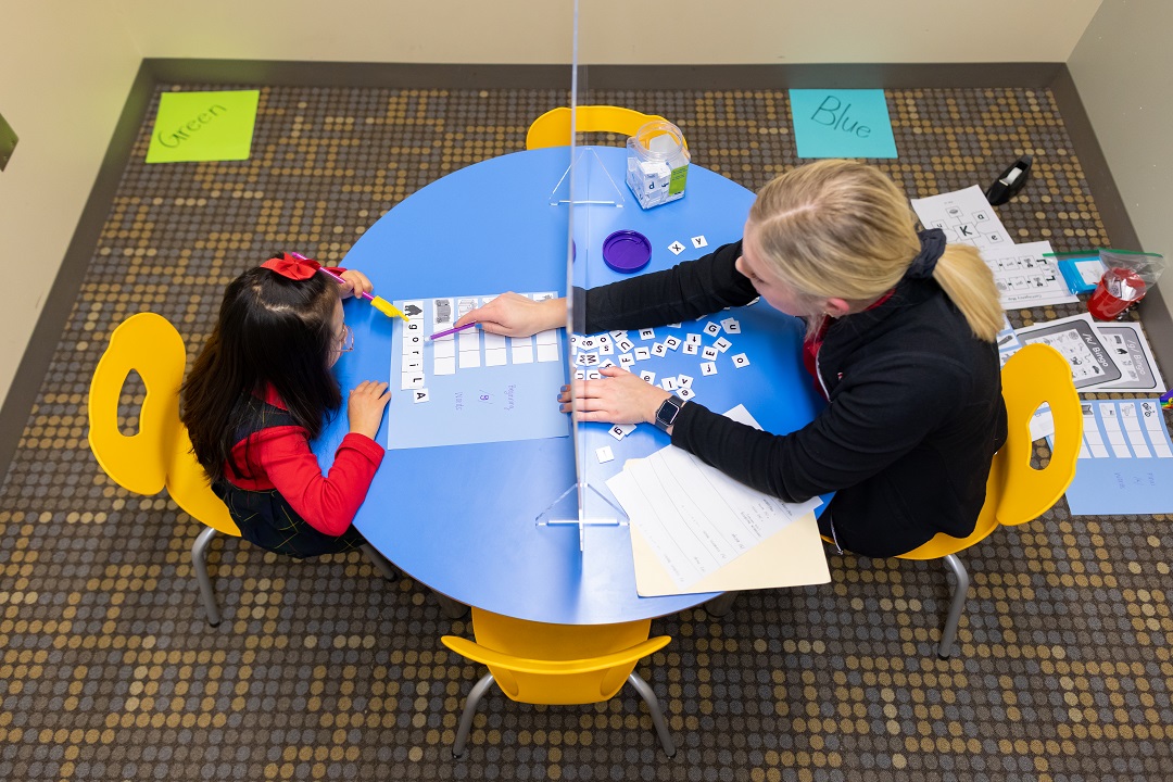 A Speech-Language student works with a child in a clinic