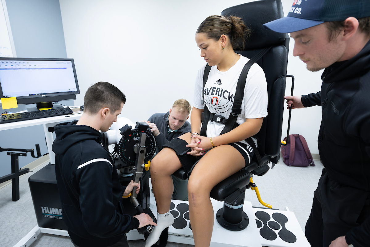 Sports medicine and biomechanics students working with a UNO athlete