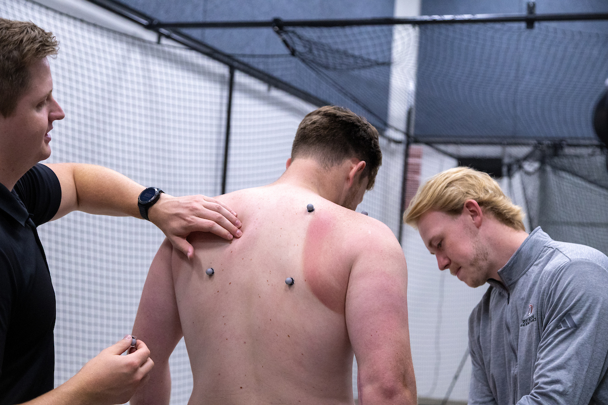 Pitcher having markers placed before motion capture biomechanics assessment. 