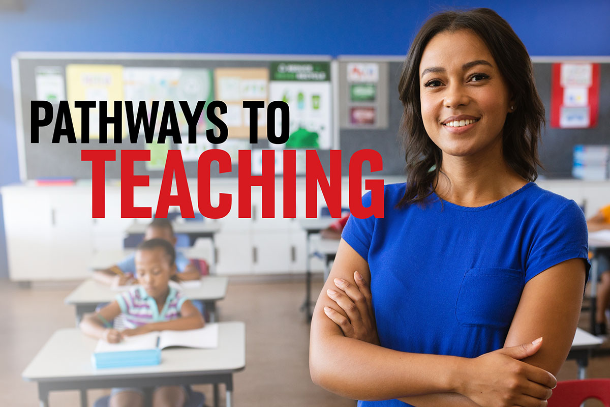 A teacher stands at the front of a classroom