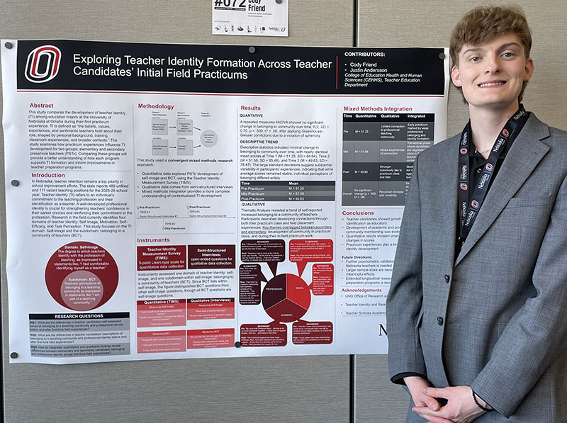 A student presents a poster at a research fair