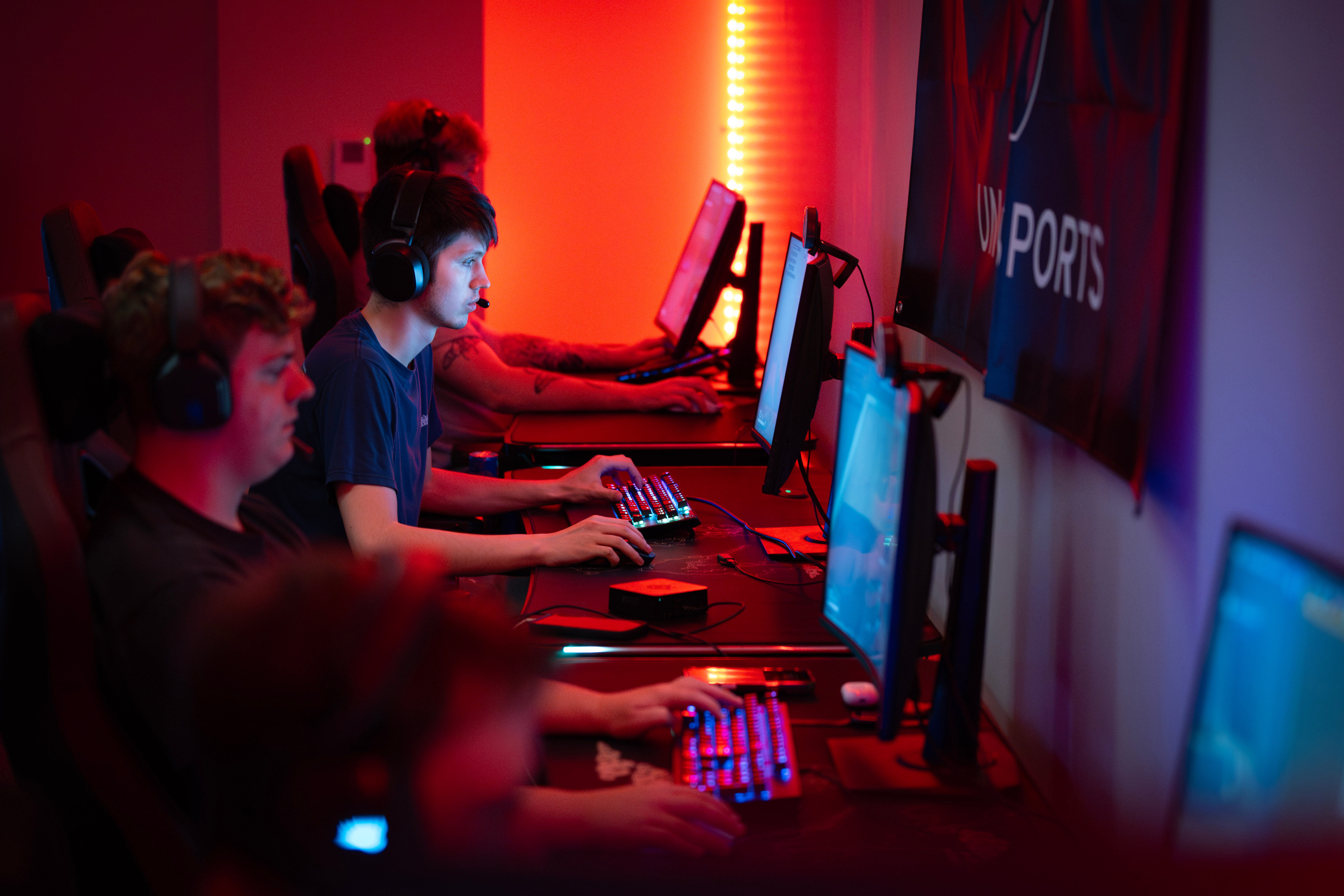Students working at gaming computers with colorful LED lighting