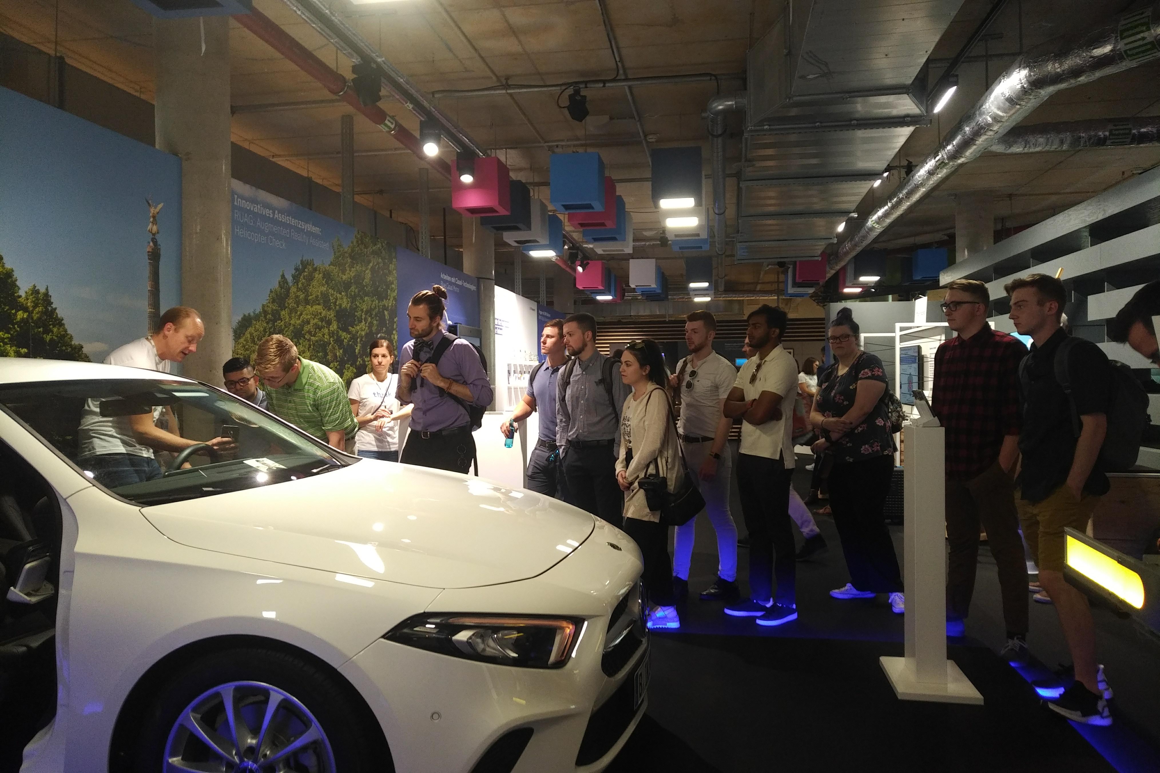 Students tour a car factory.