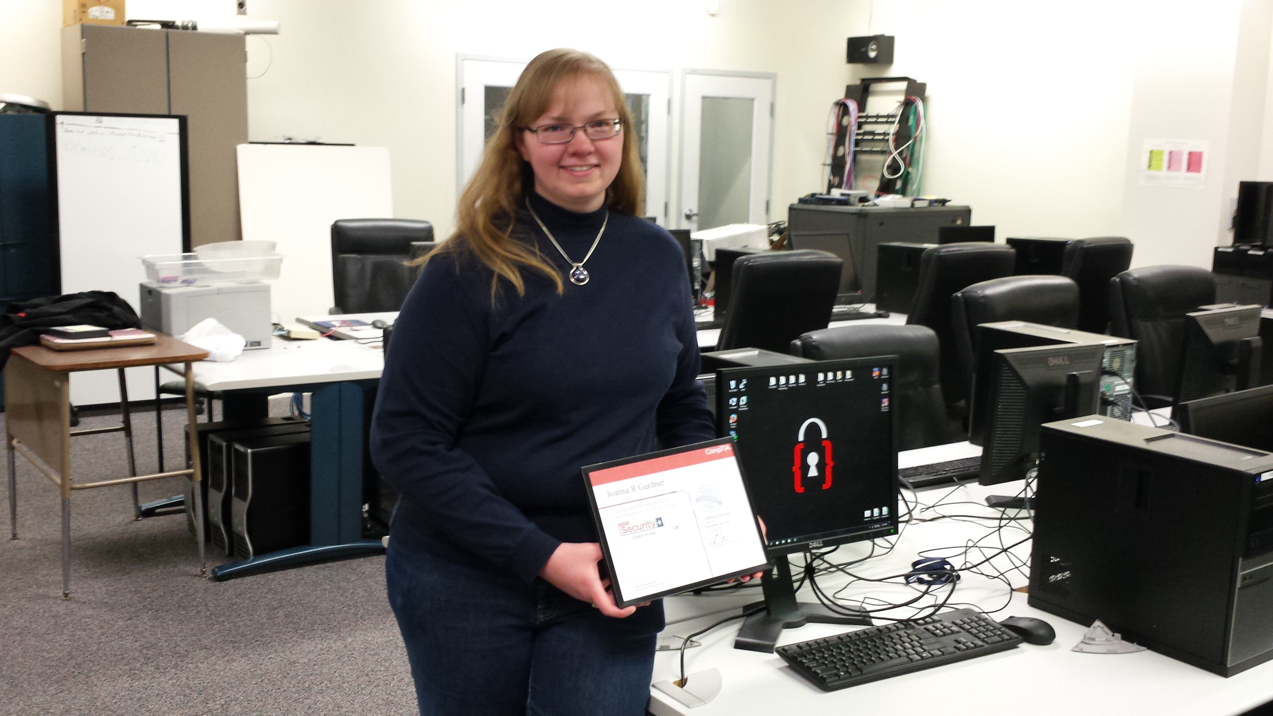 Joanna holding her Securitiy+ certificate